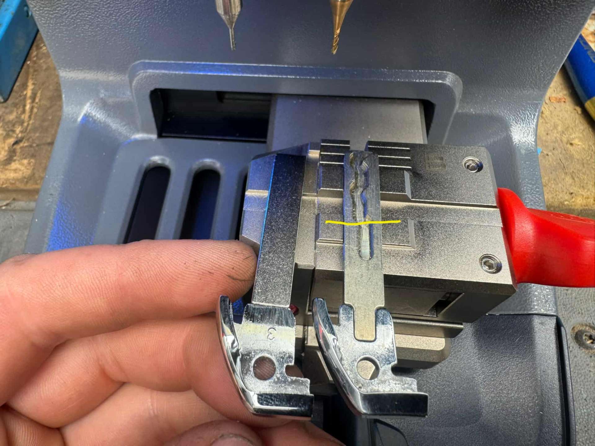 Key blade being cut on a professional key cutting machine